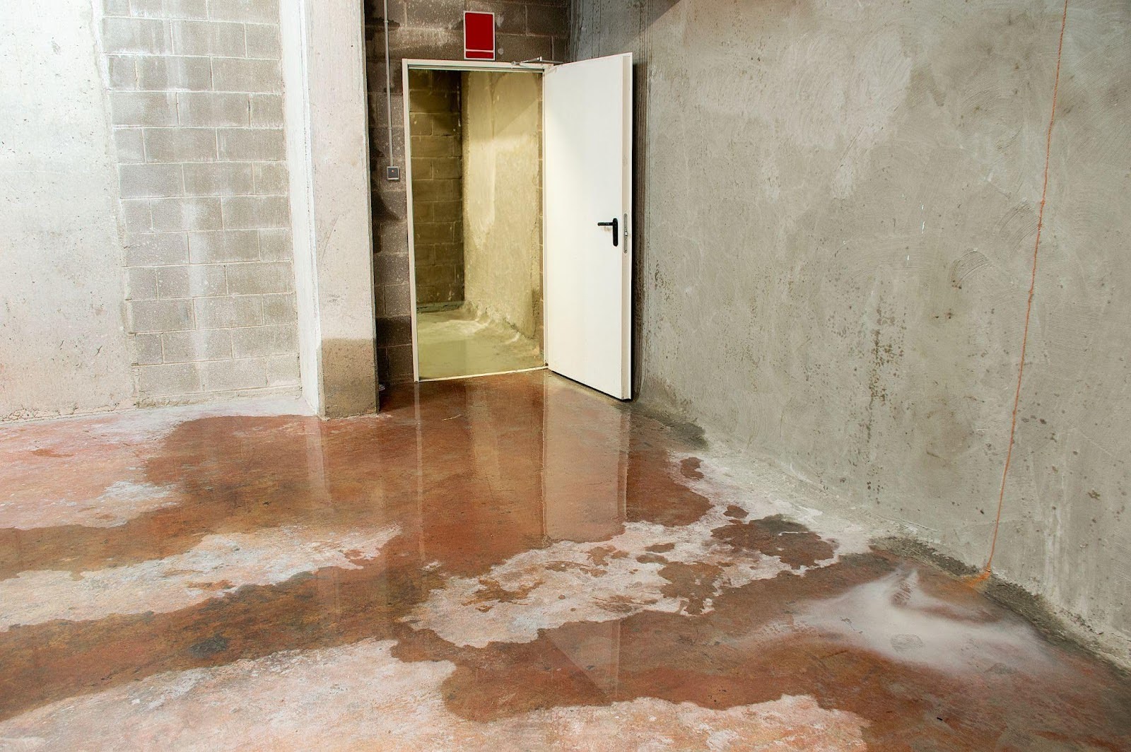 A room featuring a door and a brown floor creating a warm and inviting atmosphere