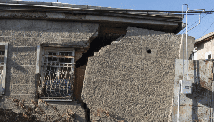 Damaged building from a storm. Have you included earthquake insurance in your policy?